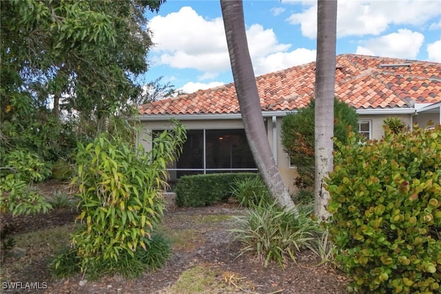 rear view of house featuring a sunroom