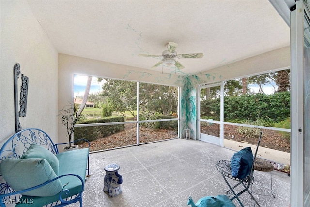 sunroom / solarium featuring ceiling fan