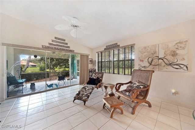 sitting room with ceiling fan, vaulted ceiling, a wealth of natural light, and light tile patterned flooring