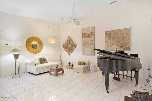 sitting room featuring tile patterned flooring and ceiling fan