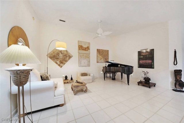 living area with ceiling fan and light tile patterned floors