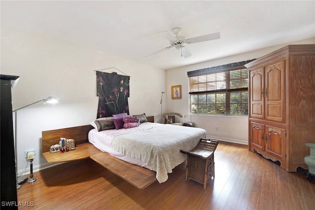 bedroom featuring hardwood / wood-style floors and ceiling fan