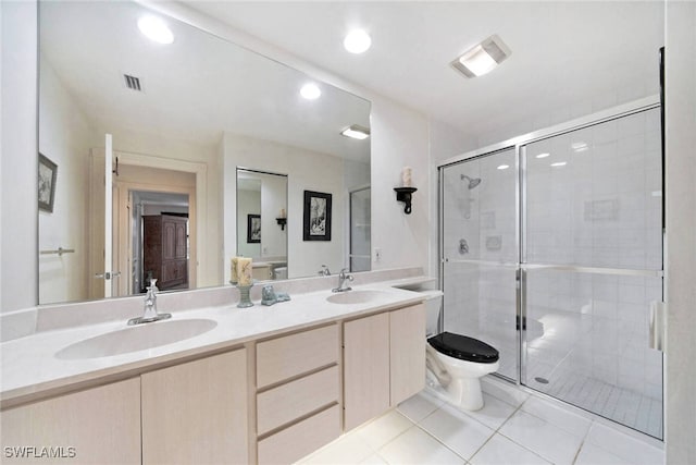 bathroom featuring tile patterned flooring, vanity, toilet, and walk in shower