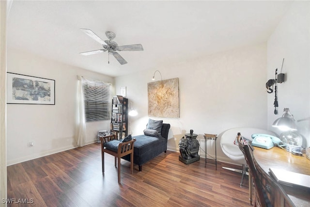 sitting room featuring dark hardwood / wood-style floors and ceiling fan