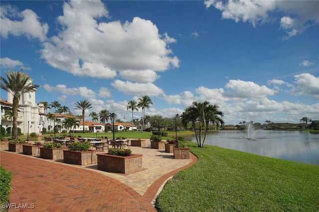 view of community featuring a yard and a water view