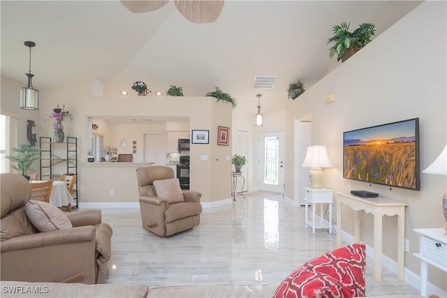 living room featuring ceiling fan and high vaulted ceiling