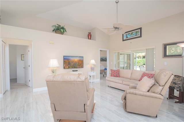 living room featuring ceiling fan, high vaulted ceiling, and light hardwood / wood-style floors