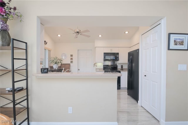 kitchen featuring black appliances, a kitchen breakfast bar, kitchen peninsula, ceiling fan, and white cabinetry