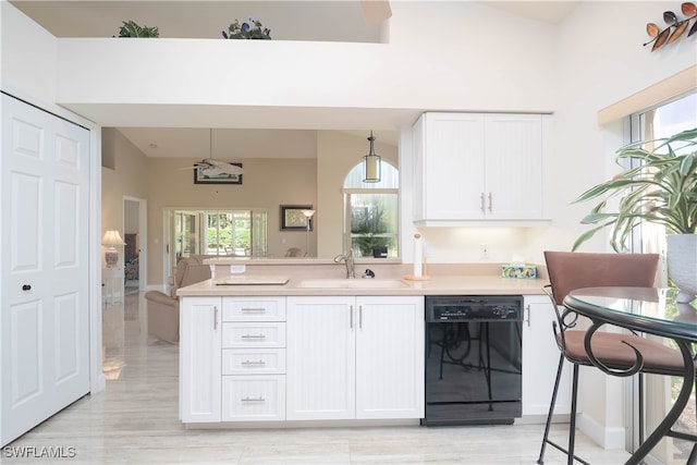 kitchen featuring dishwasher, white cabinets, plenty of natural light, and sink