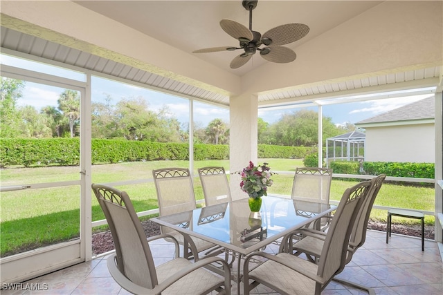 sunroom / solarium with ceiling fan and lofted ceiling