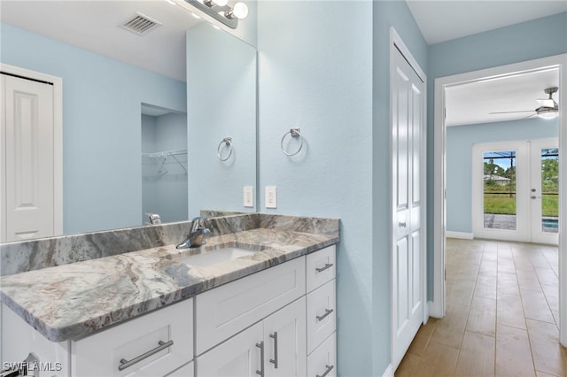 bathroom with vanity, ceiling fan, and wood-type flooring