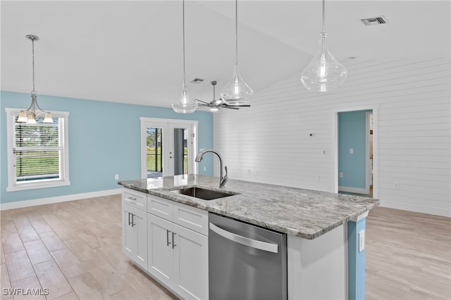 kitchen with dishwasher, a kitchen island with sink, white cabinets, hanging light fixtures, and vaulted ceiling