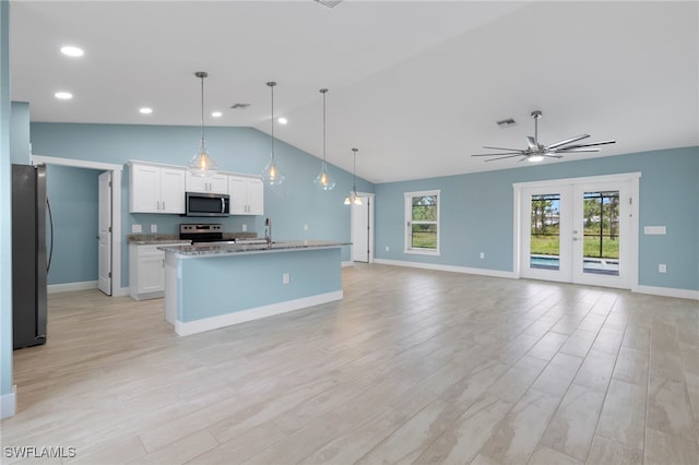 kitchen featuring white cabinets, appliances with stainless steel finishes, light hardwood / wood-style flooring, and pendant lighting