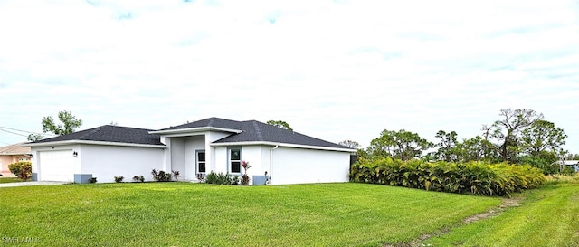 view of front of property with a front yard and a garage