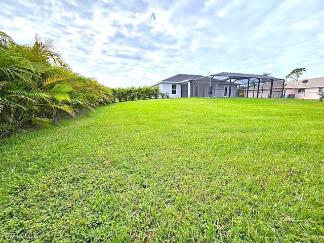 view of yard featuring glass enclosure