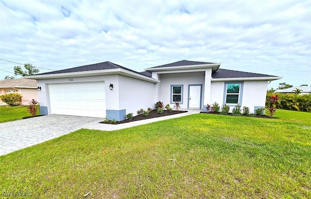 view of front facade with a front yard, french doors, and a garage