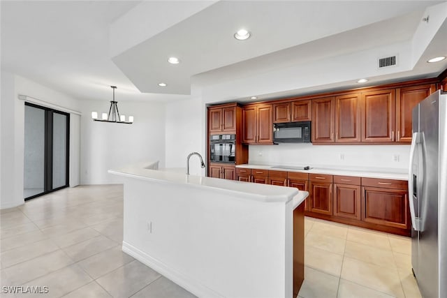 kitchen with black appliances, light tile patterned floors, pendant lighting, an island with sink, and a chandelier