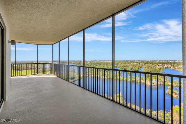 unfurnished sunroom with a water view