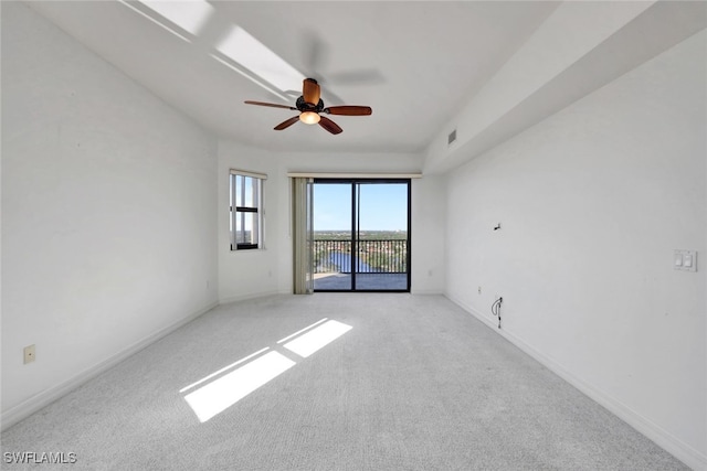 carpeted spare room featuring ceiling fan