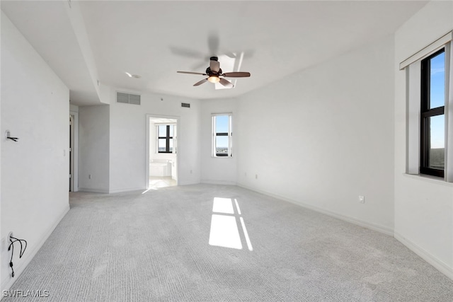 unfurnished room featuring ceiling fan and light carpet