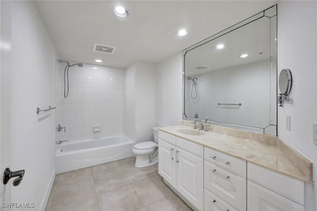 full bathroom featuring vanity, tile patterned floors, tiled shower / bath, and toilet