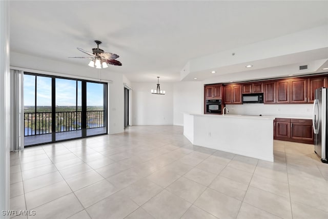 kitchen with pendant lighting, black appliances, a center island with sink, and light tile patterned flooring