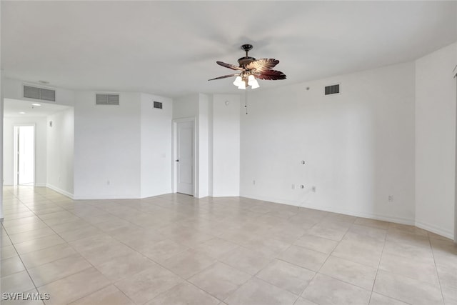 spare room with ceiling fan and light tile patterned floors