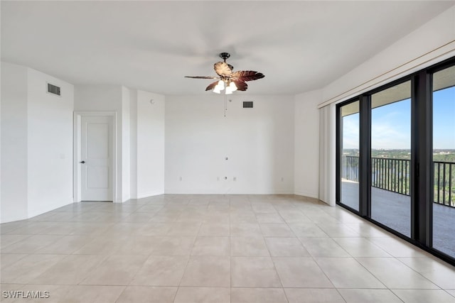 spare room with light tile patterned floors and ceiling fan