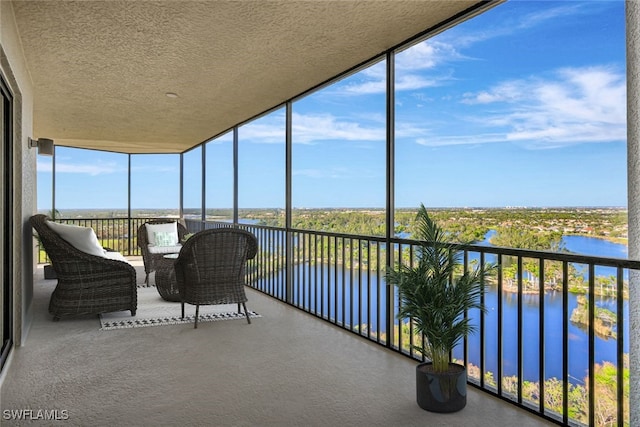 unfurnished sunroom with a water view