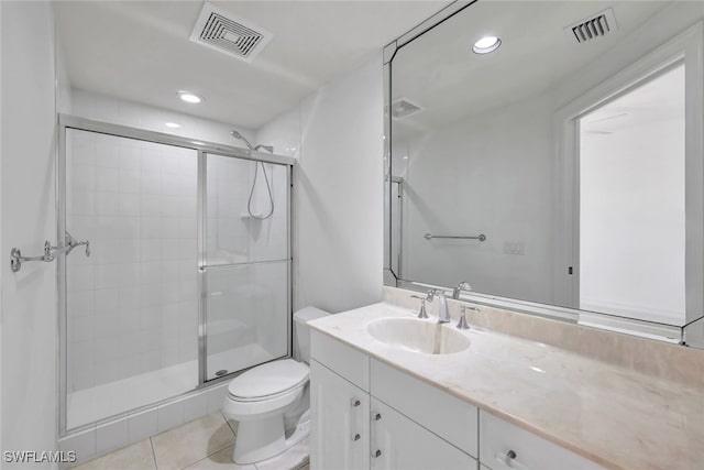 bathroom featuring toilet, vanity, tile patterned flooring, and walk in shower