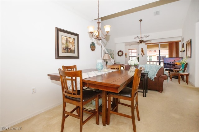 carpeted dining area with ceiling fan with notable chandelier