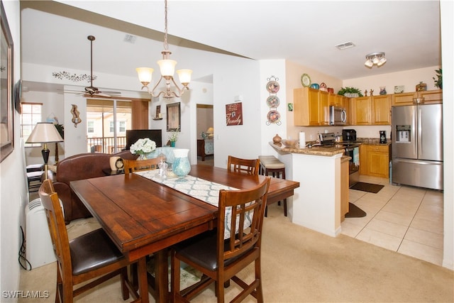 carpeted dining area with ceiling fan with notable chandelier