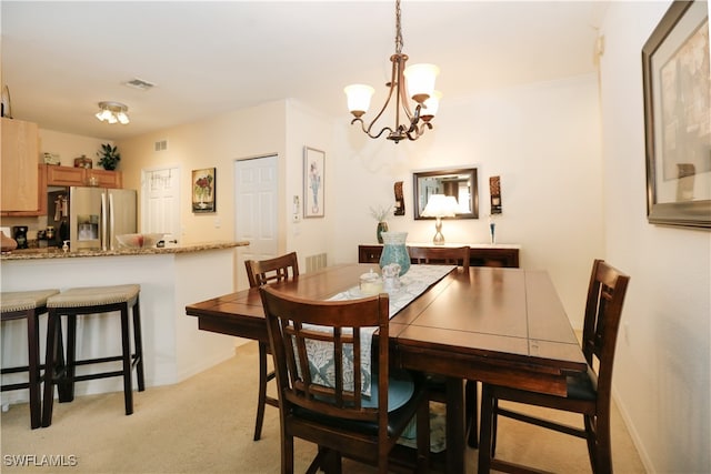 carpeted dining space with a notable chandelier