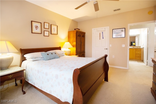 carpeted bedroom featuring ensuite bathroom and ceiling fan