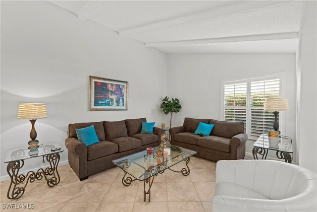 tiled living room featuring vaulted ceiling with beams