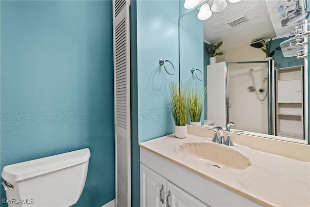 full bathroom featuring a closet, visible vents, toilet, a shower stall, and vanity