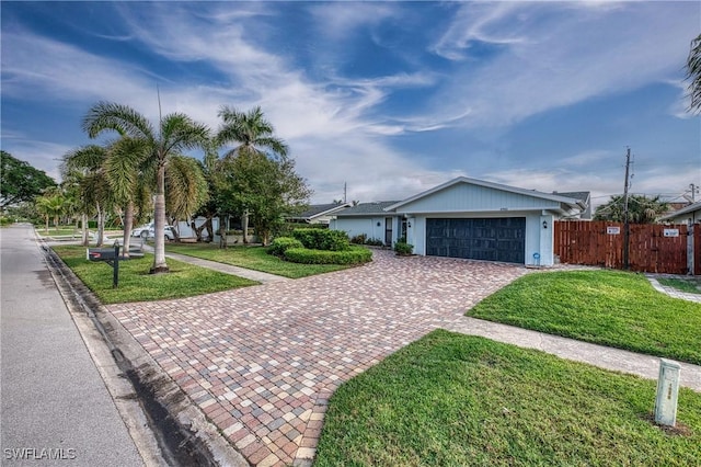 ranch-style house with a front yard and a garage