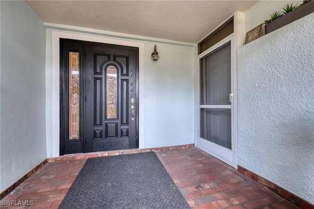 view of exterior entry featuring stucco siding