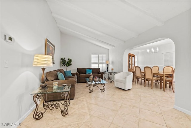 living room with light tile patterned floors, baseboards, arched walkways, vaulted ceiling with beams, and a notable chandelier