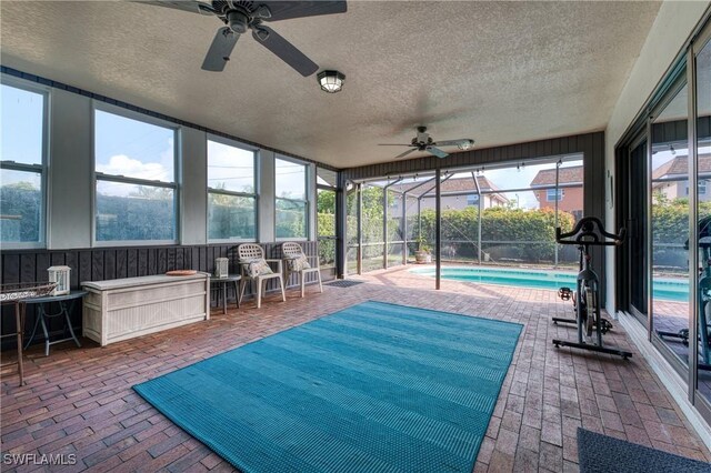 sunroom / solarium featuring ceiling fan and a healthy amount of sunlight