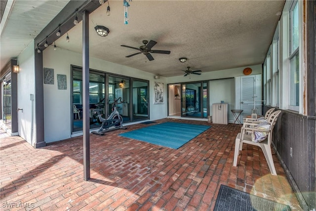 exterior space featuring a ceiling fan