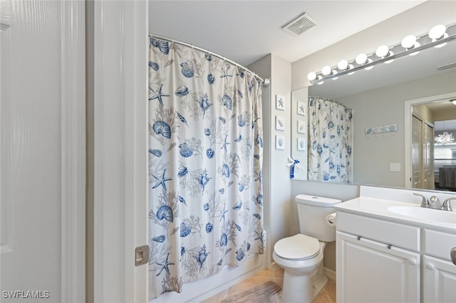 full bathroom with shower / tub combo, vanity, toilet, and tile patterned floors