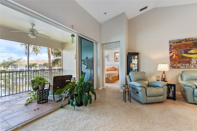 living room featuring carpet flooring, ceiling fan, and vaulted ceiling