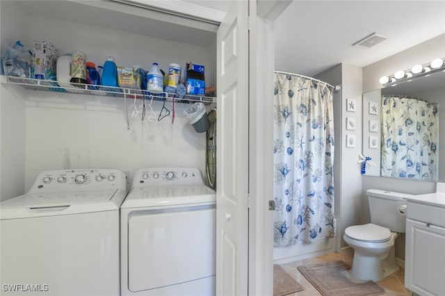 clothes washing area with separate washer and dryer