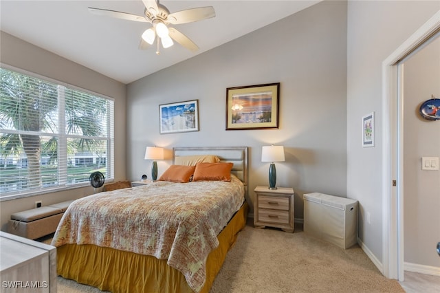 carpeted bedroom with ceiling fan and vaulted ceiling