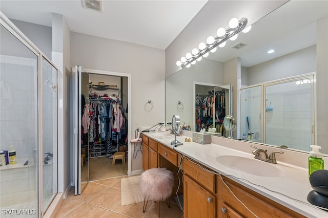 bathroom with vanity, tile patterned floors, and walk in shower