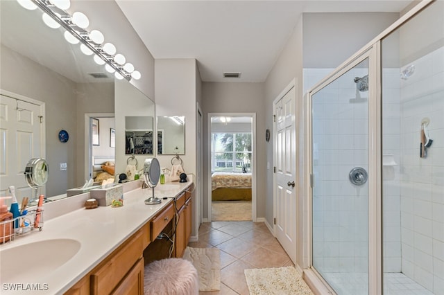 bathroom with tile patterned floors, vanity, and a shower with door