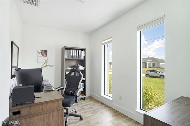 office with light wood-type flooring