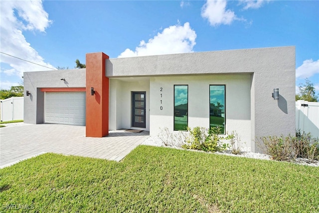 view of front of house featuring a garage and a front lawn