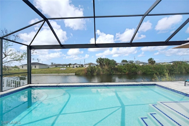 view of pool with glass enclosure, a water view, and a patio